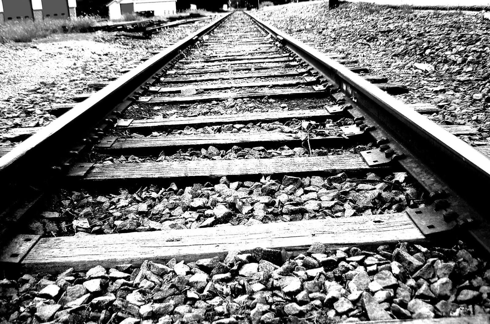Black-White-Close-Up-Of-Railroad-Tracks-Ties-Stone.jpg