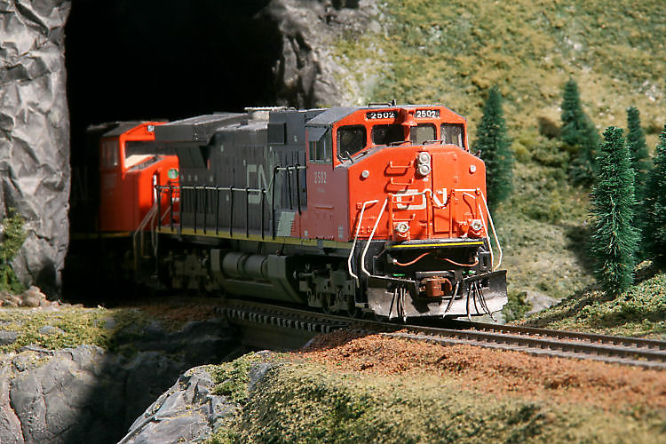 CN 2502 comes out of the tunnel leading the train