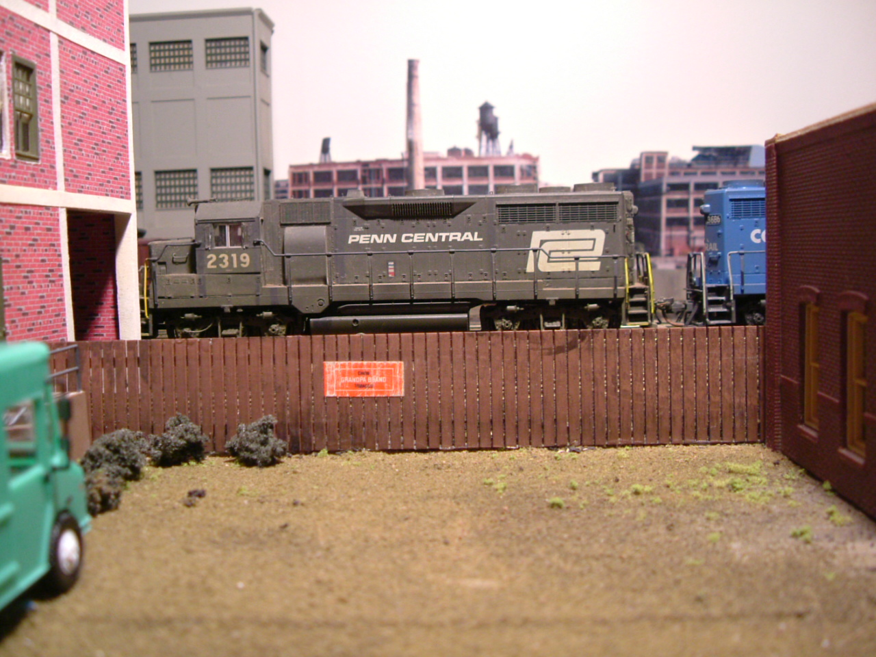 Weathered GP-35s pulling cut of cars down track 1